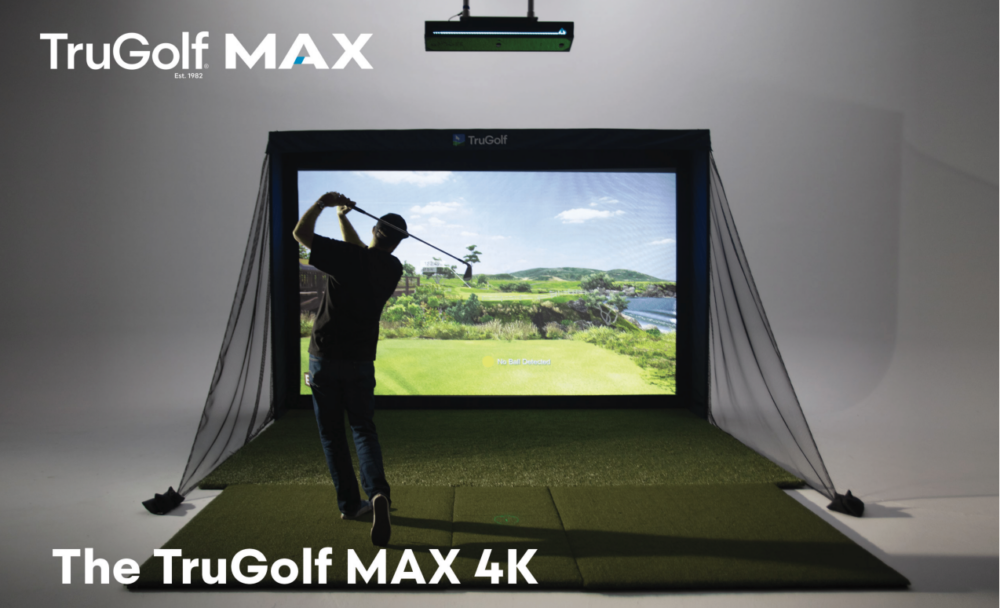 Golfer mid-swing inside a TruGolf MAX 4K simulator enclosure