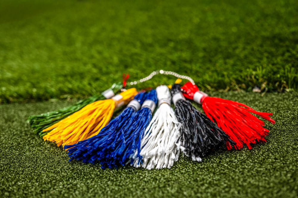 Golf club headcovers resting on simulator turf