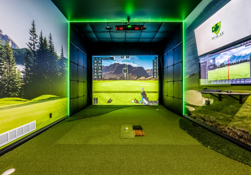 Completed custom golf simulator installation with enclosure, screen and accent lighting
