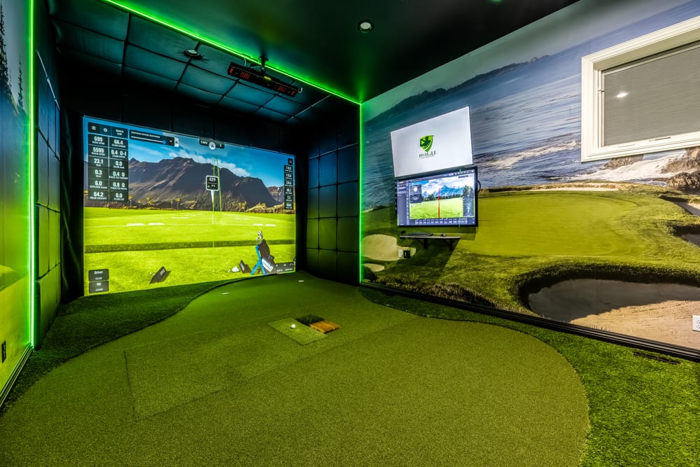 Custom golf simulator room with turf flooring, impact screen and green LED accent lighting