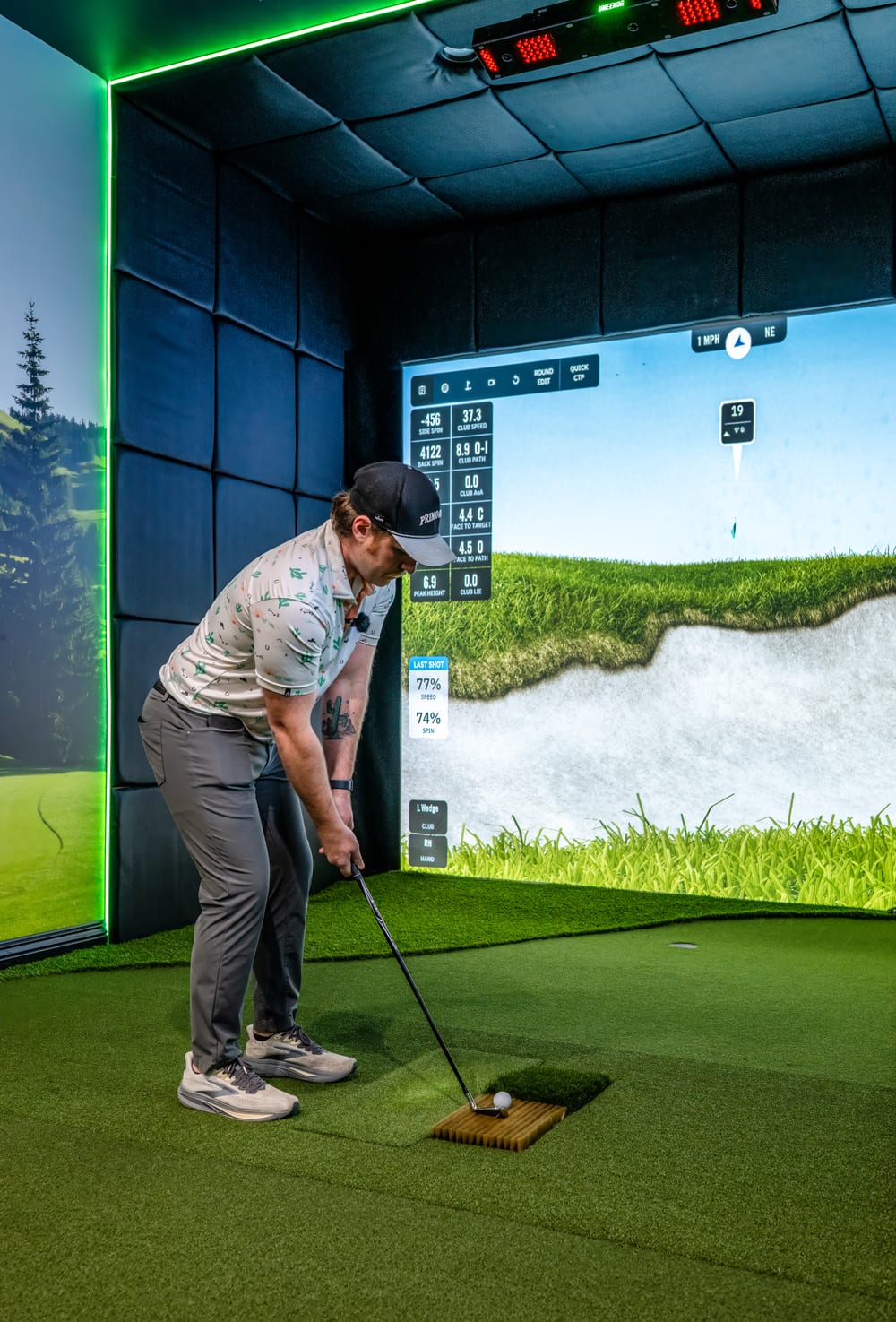Golfer playing a wedge shot from a simulated bunker lie